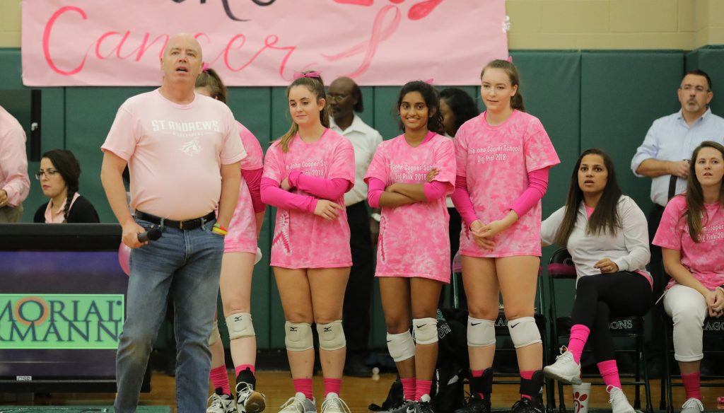 Players in Lisa's team standing and wearing pink shirts.