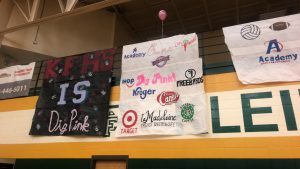Klein Forest High School hung two banners. One reads "KFHS is Dig Pink" and the other includes drawings of logos of companies which contributed to the silent auction.