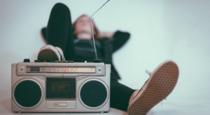 Girl laying down utilizing music therapy.